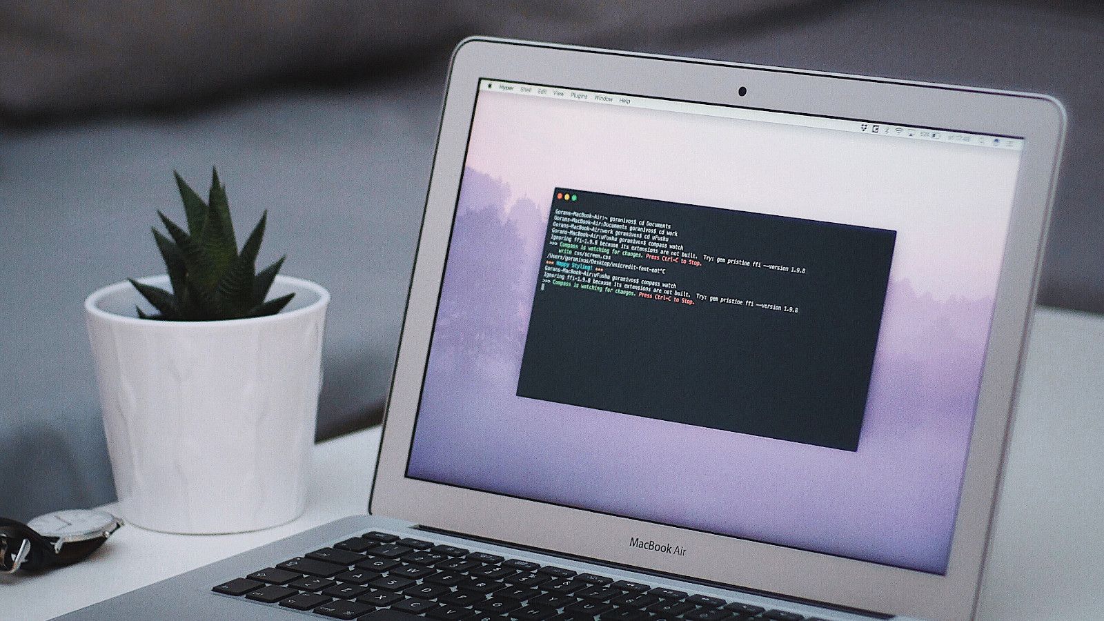 Developer's workspace showing code compilation in progress, representing the systematic configuration and automation that dotfiles bring to development environments